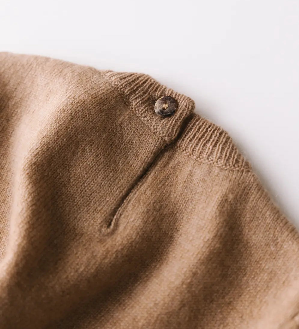 Close-up of the baby cashmere sweater in brown – fine knit texture and shell button details