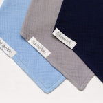 Soloveable multicolor muslin bandana bib set for babies in blue, grey and navy, close up.