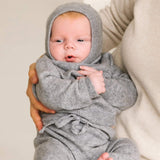Baby wearing soft heather grey cashmere balaclava, warm knitted hood for infants.