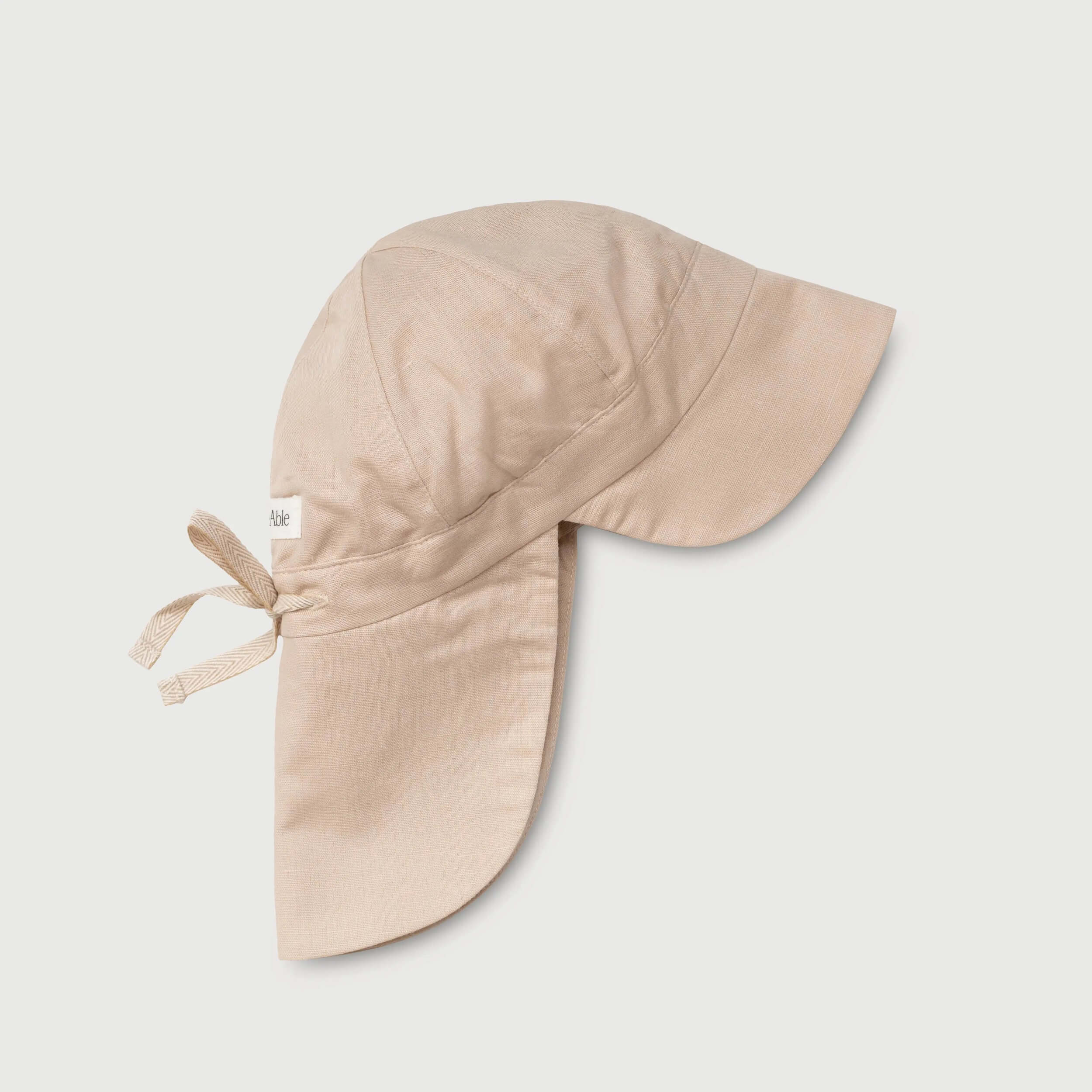Beige linen sun hat for babies with neck protection and adjustable tie, side view