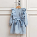 Back view of blue linen girls dress with bow tie and buttons, ruffle sleeves, timeless elegant children's outfit.