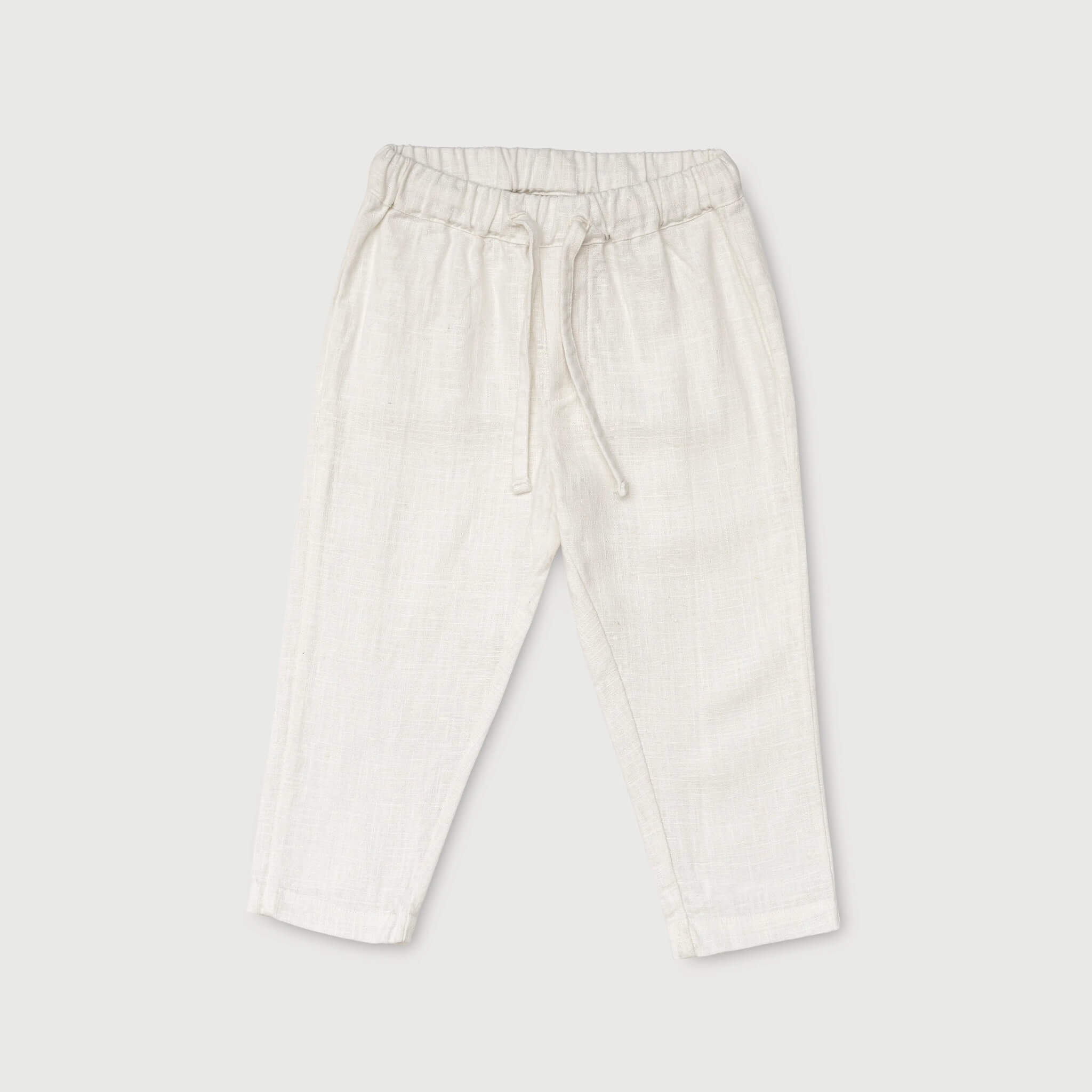 Front view of white linen pants for babies and toddlers with elastic waistband and drawstring.