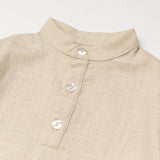 Close-up of the collarless neckline and button placket on the beige linen baby and toddler long-sleeve shirt.