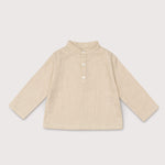 Front view of long-sleeve beige linen shirt for babies and toddlers with a collarless design and three-button placket.