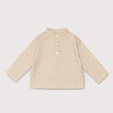 Front view of long-sleeve beige linen shirt for babies and toddlers with a collarless design and three-button placket.