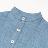 Close-up of the collarless neckline and button placket on the blue linen baby and toddler long-sleeve shirt.