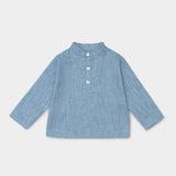 Front view of long-sleeve blue linen shirt for babies and toddlers with a collarless design and three-button placket.