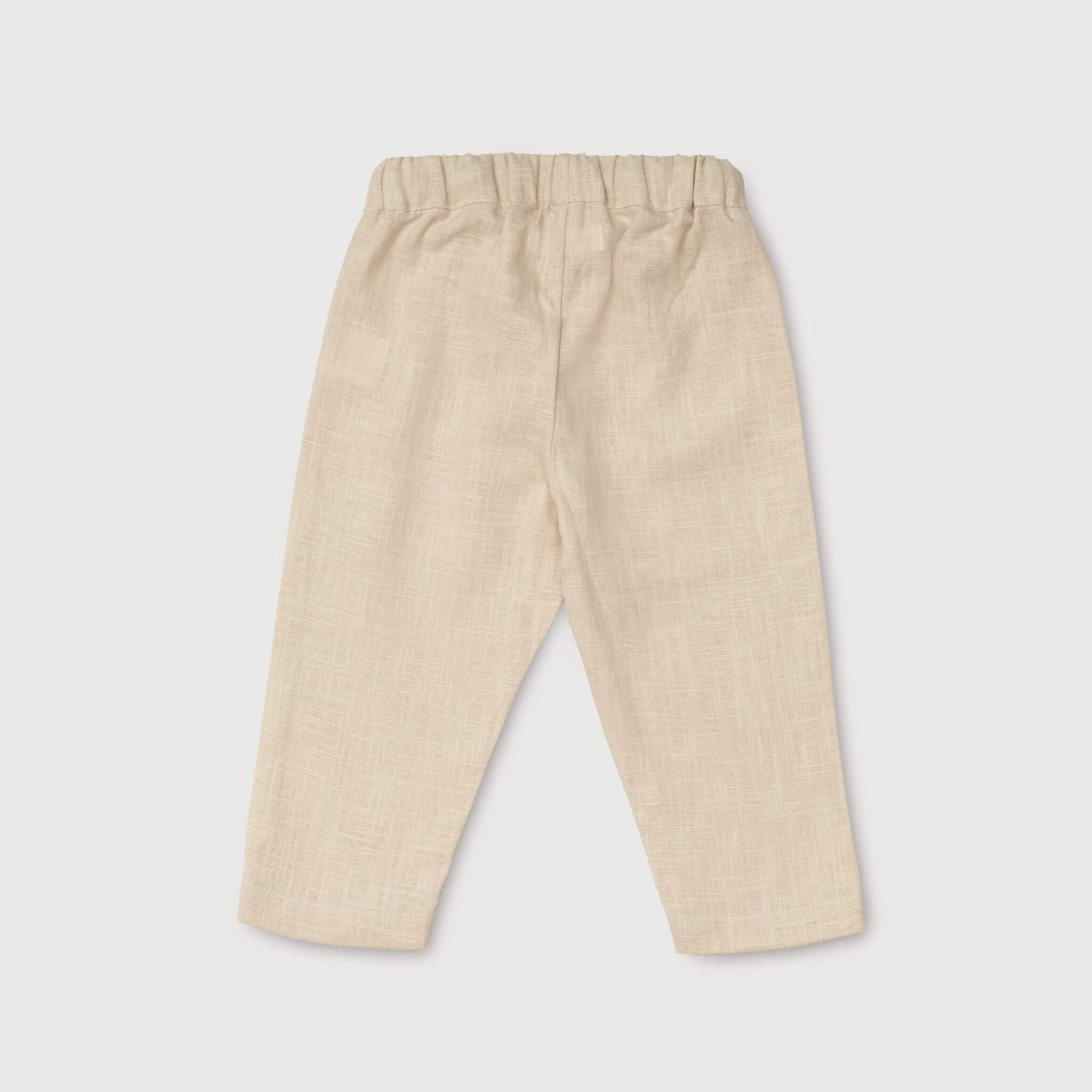 Back view of lightweight beige linen pants for babies and toddlers.