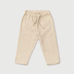 Front view of long beige linen pants for babies and toddlers with elastic waistband and drawstring.
