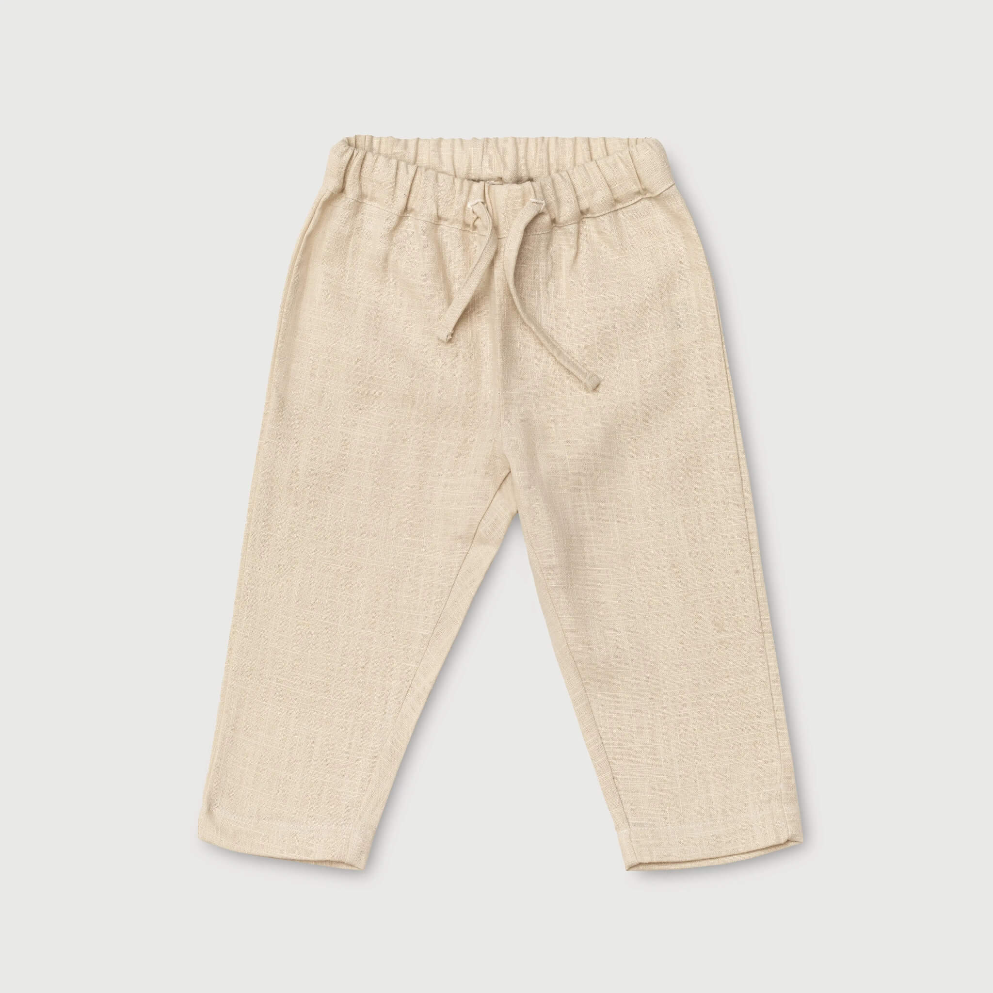 Front view of long beige linen pants for babies and toddlers with elastic waistband and drawstring.
