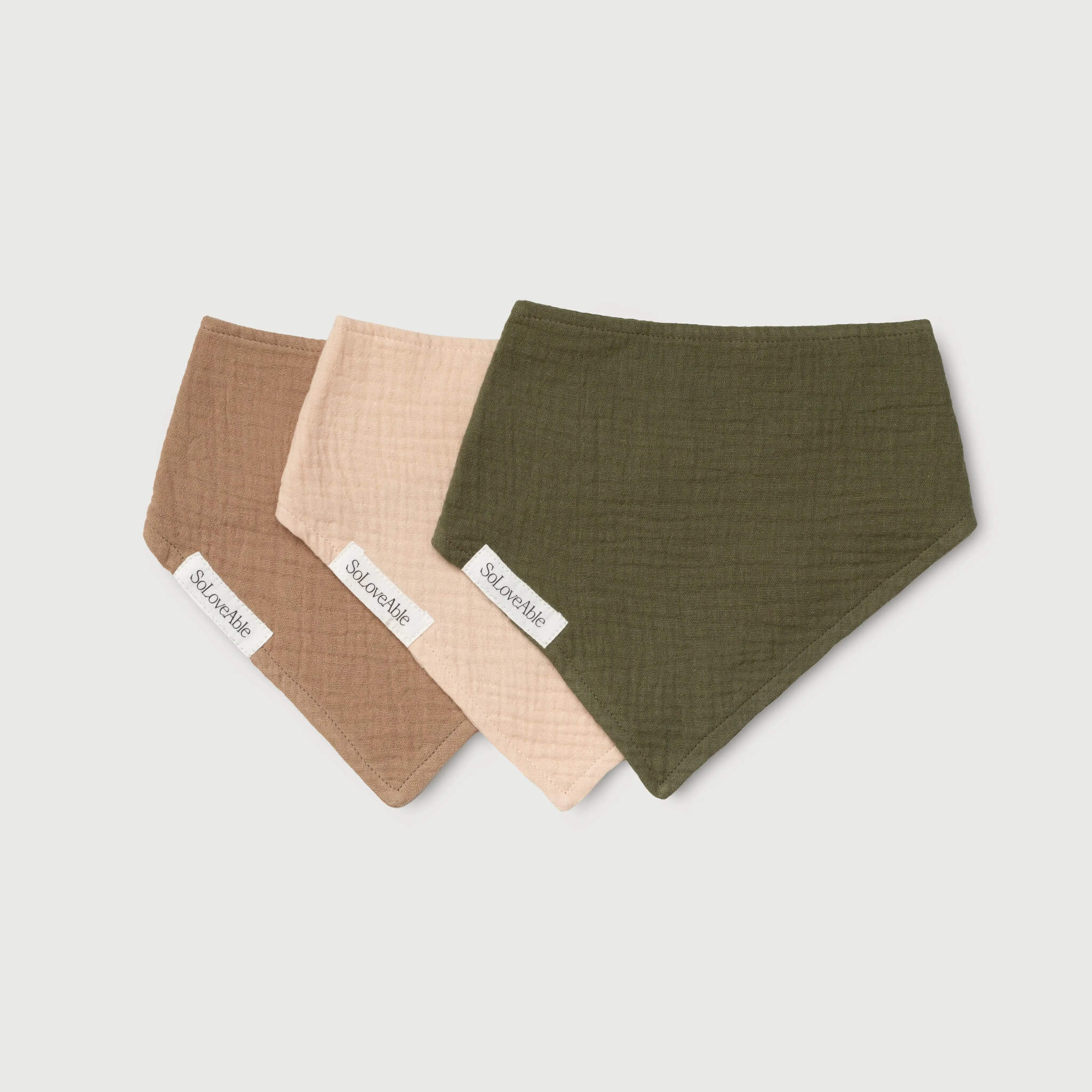 Soloveable muslin baby bandana bibs in brown, beige and green displayed as a 3-pack.