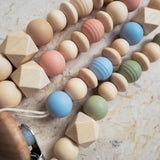 Close-up of silicone and wooden beads used in the handmade pacifier clip.