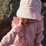 Pink linen hat worn by child – Soloveable