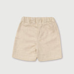 Back view of lightweight short beige linen pants for babies and toddlers.