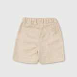 Back view of lightweight short beige linen pants for babies and toddlers.