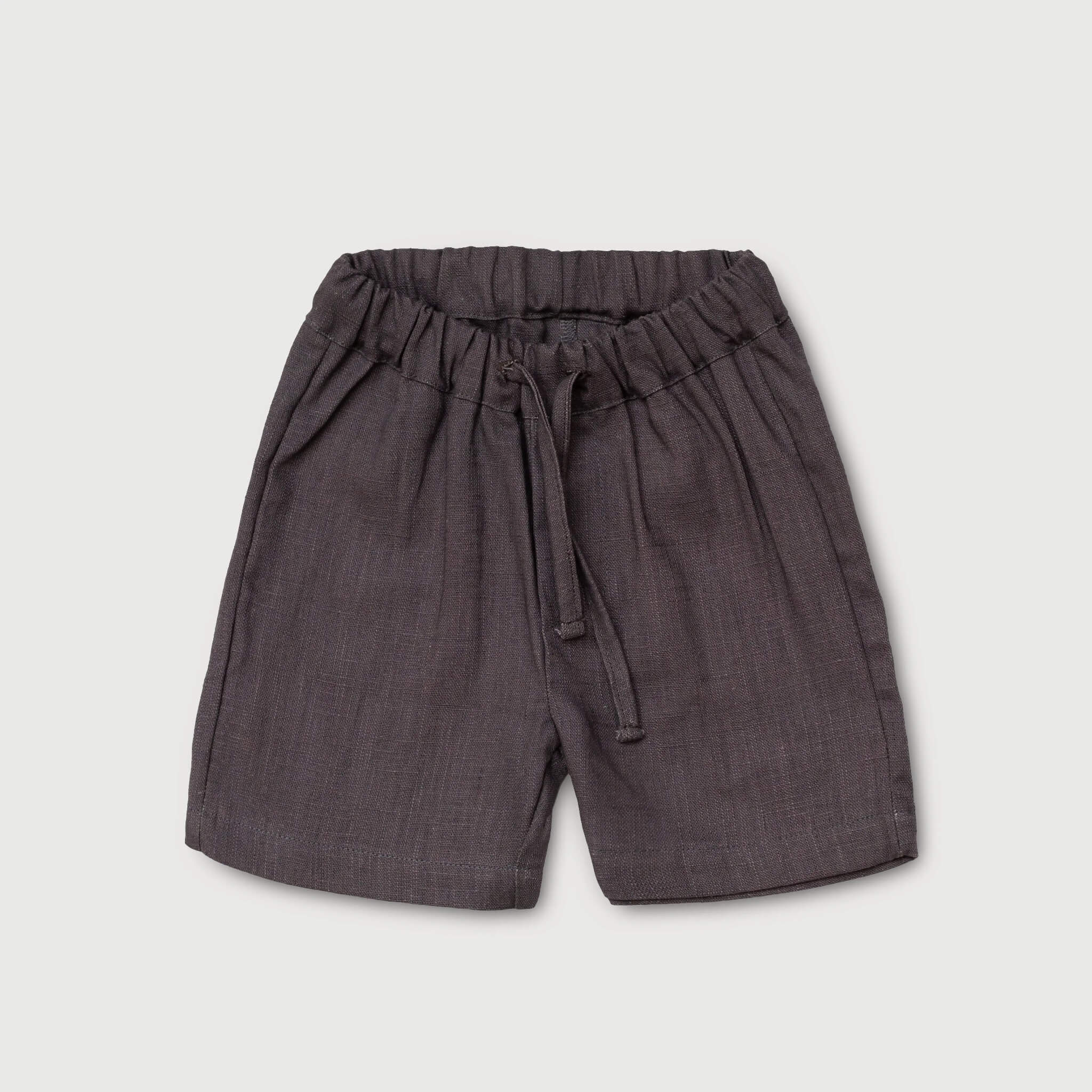 Front view of short brown linen pants for babies and toddlers with elastic waistband and drawstring.