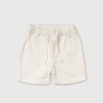 Front view of short white linen pants for babies and toddlers with elastic waistband and drawstring.