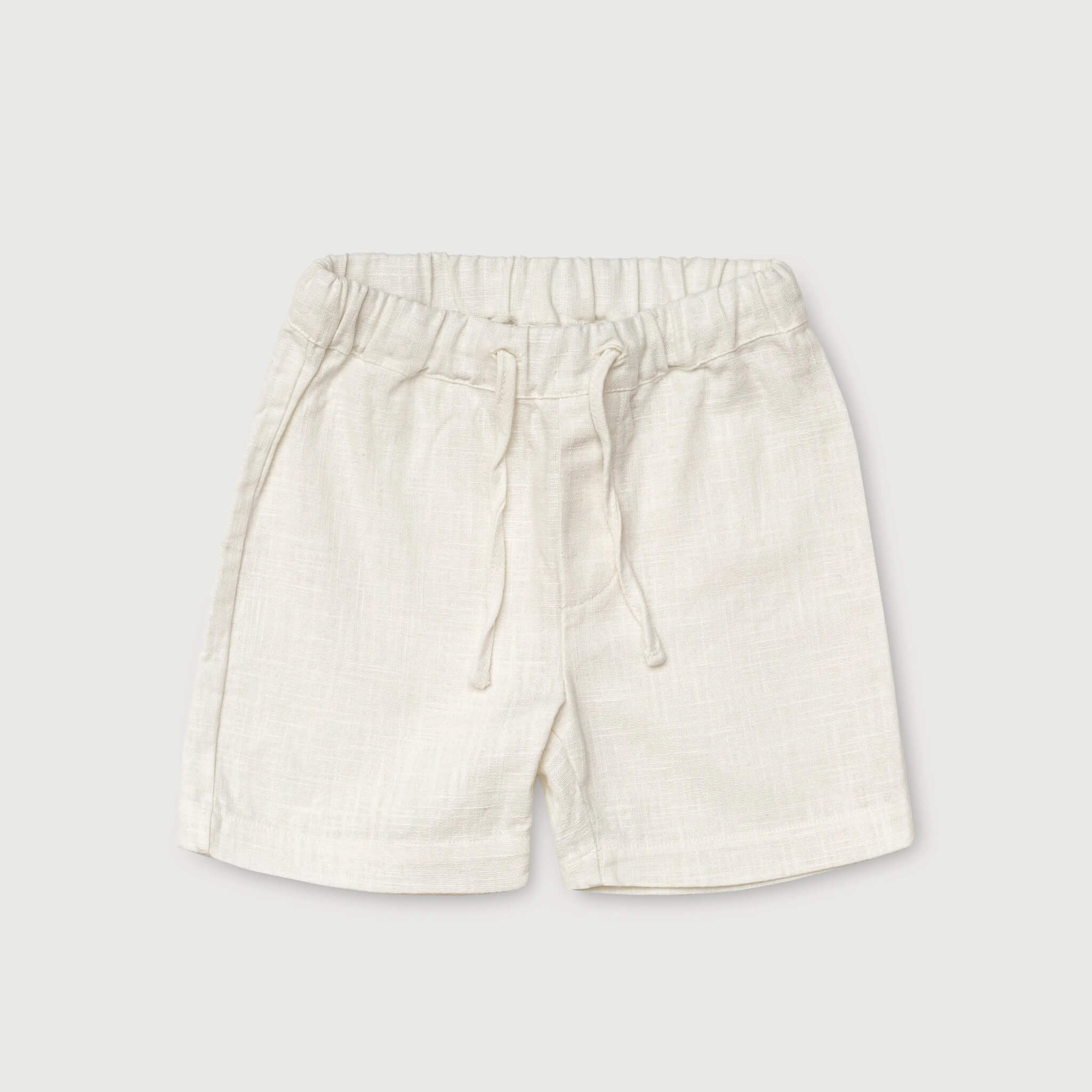 Front view of short white linen pants for babies and toddlers with elastic waistband and drawstring.