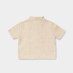 Back view of a lightweight beige linen short-sleeve shirt for babies and toddlers.