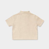 Back view of a lightweight beige linen short-sleeve shirt for babies and toddlers.