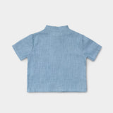 Back view of a lightweight blue linen short-sleeve shirt for babies and toddlers.