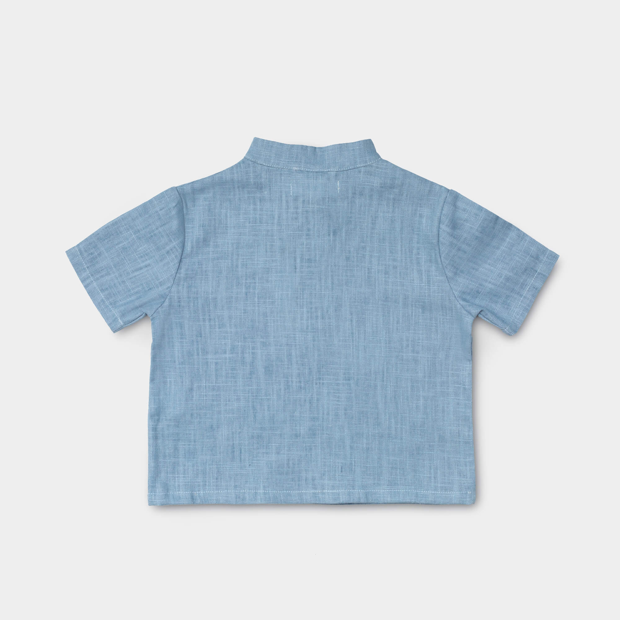Back view of a lightweight blue linen short-sleeve shirt for babies and toddlers.