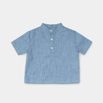 Front view of a short-sleeve blue linen shirt for babies and toddlers with a three-button placket.