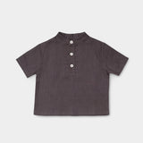 Front view of a short-sleeve brown linen shirt for babies and toddlers with a three-button placket.