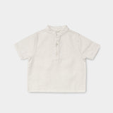 Front view of a short-sleeve white linen shirt for babies and toddlers with a three-button placket.
