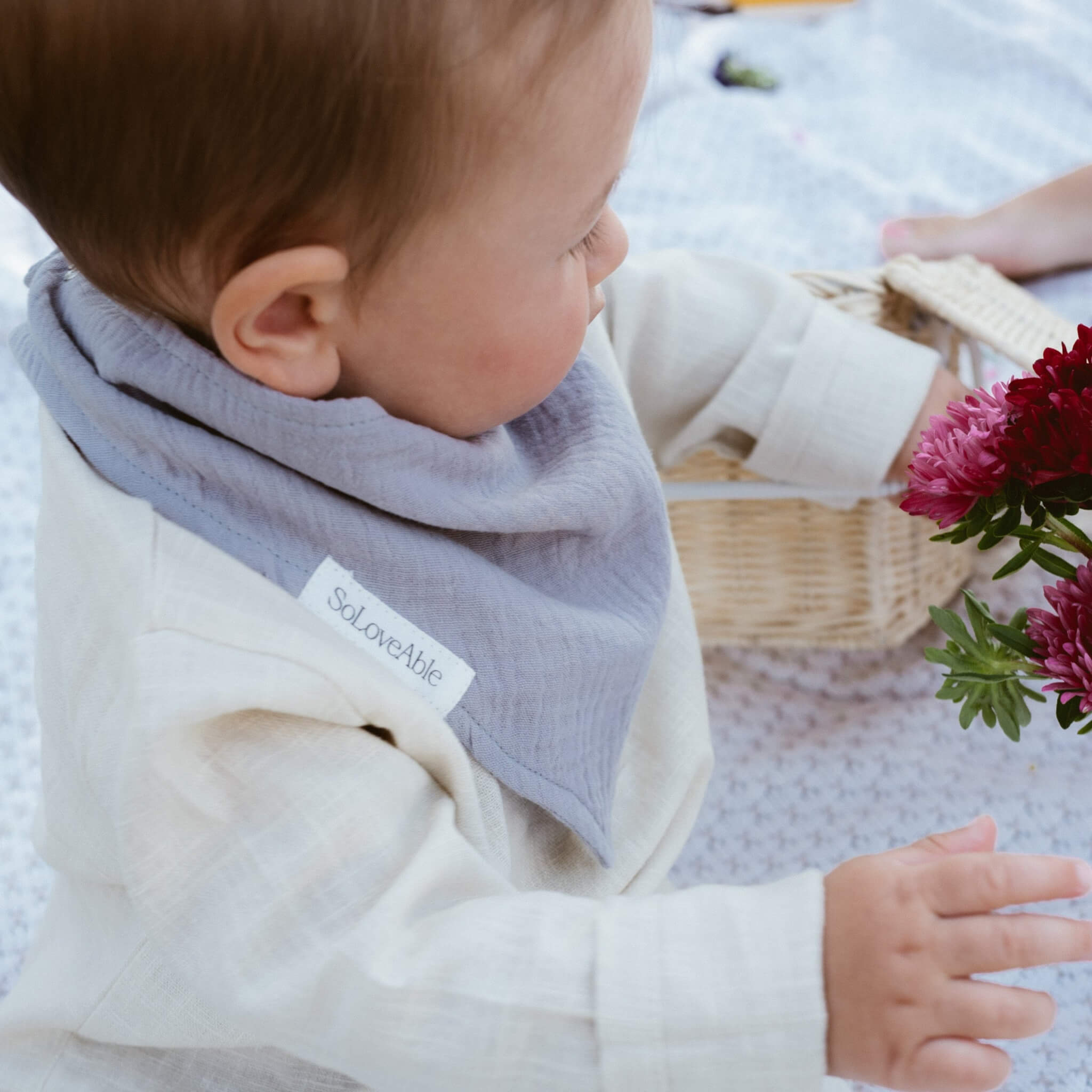Close-up of a child wearing a soft linen garment from SoLoveAble, highlighting the natural texture of the fabric.