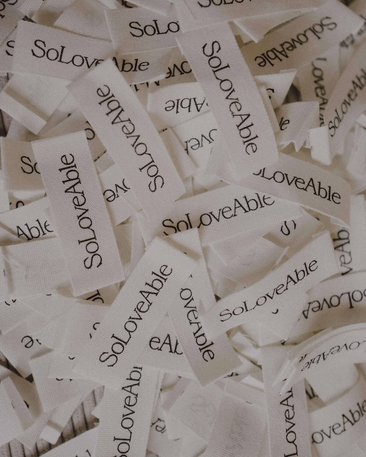 SoLoveAble brand labels made from organic cotton, showcasing sustainable and high-quality baby clothing.
