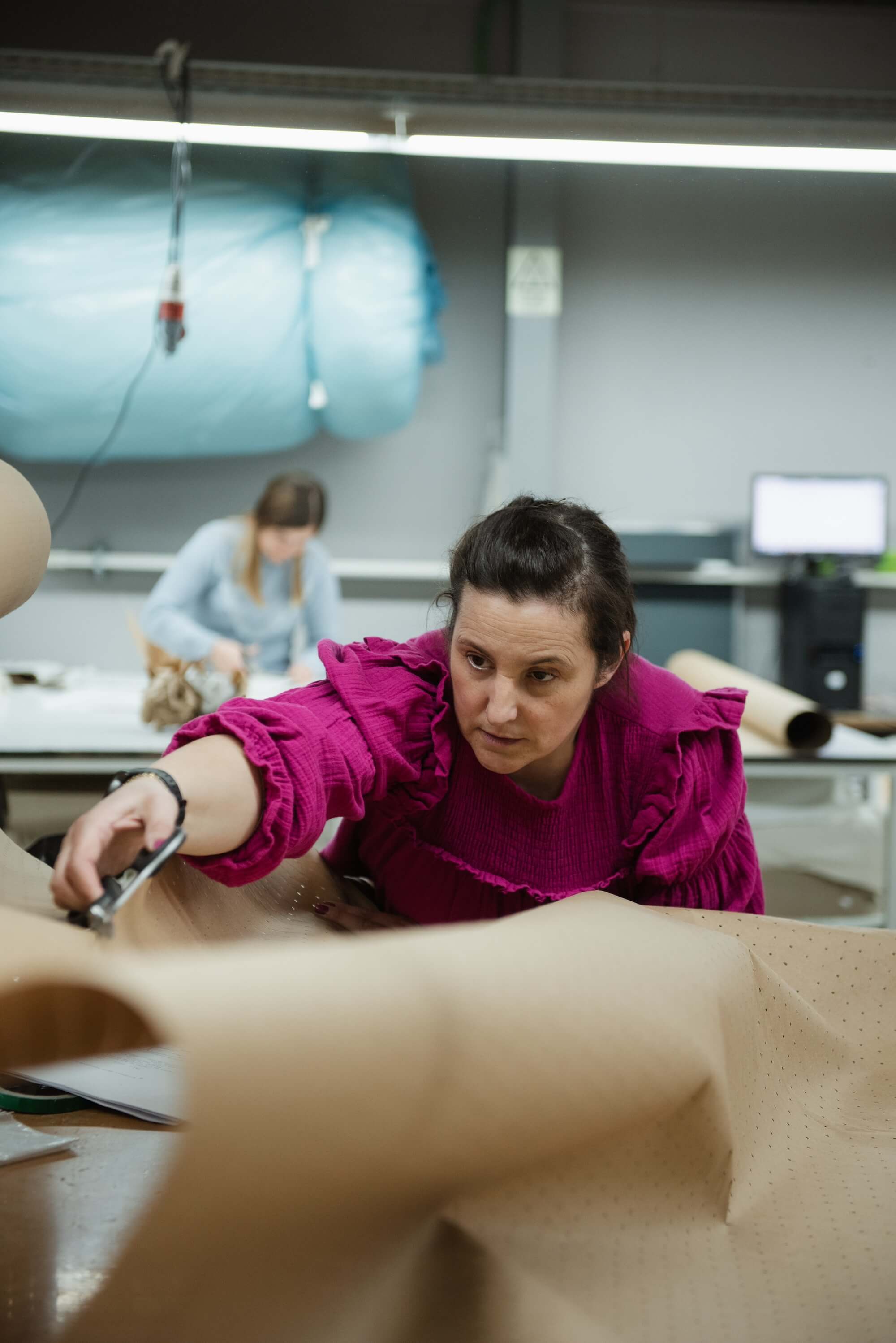 Close-up of sustainable handmade garment production process for SoLoveAble baby clothing.
