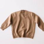 Caramel brown baby cashmere sweater shown from the back on a white background.