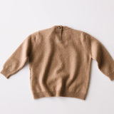 Caramel brown baby cashmere sweater shown from the back on a white background.
