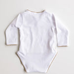 Back view of white baby bodysuit with caramel brown crochet trim.