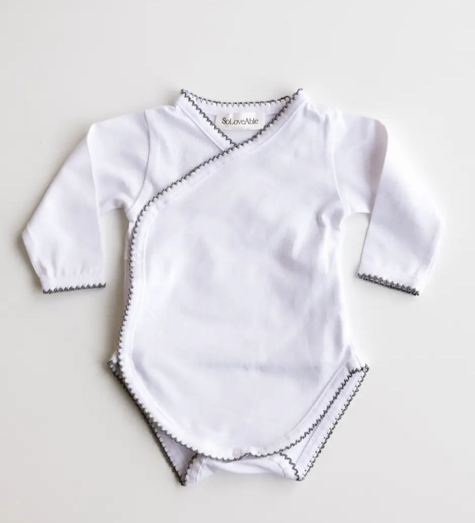 Baby bodysuit in white with heather grey crochet trim, front view.