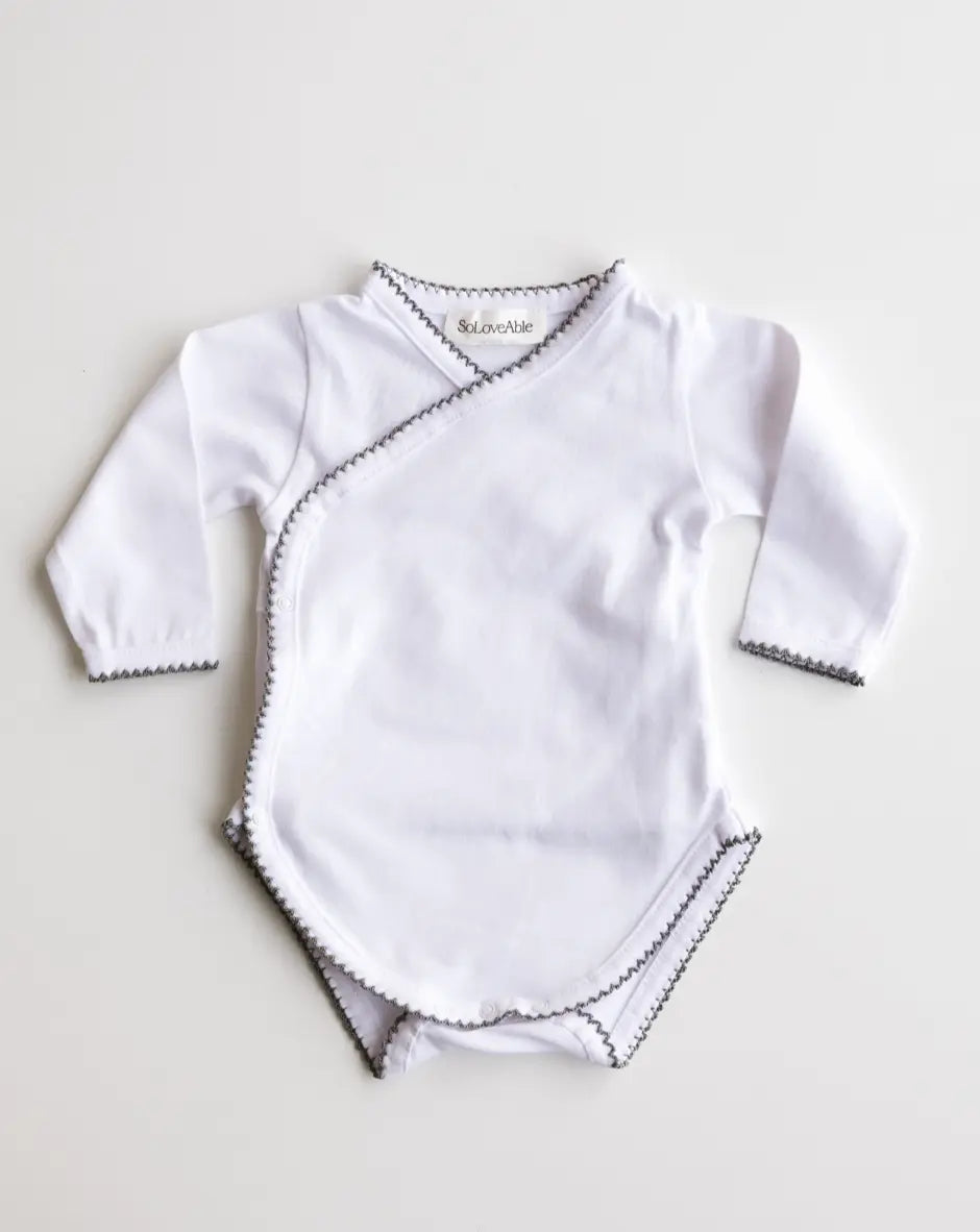 Baby bodysuit in white with heather grey crochet trim, front view.