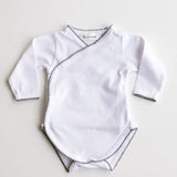 Baby bodysuit in white with heather grey crochet trim, front view.
