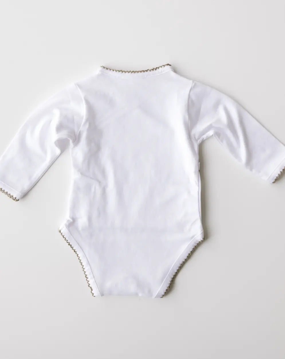 Back view of white baby bodysuit with sage green crochet trim.