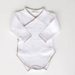 Baby bodysuit in white with sage green crochet trim, front view.
