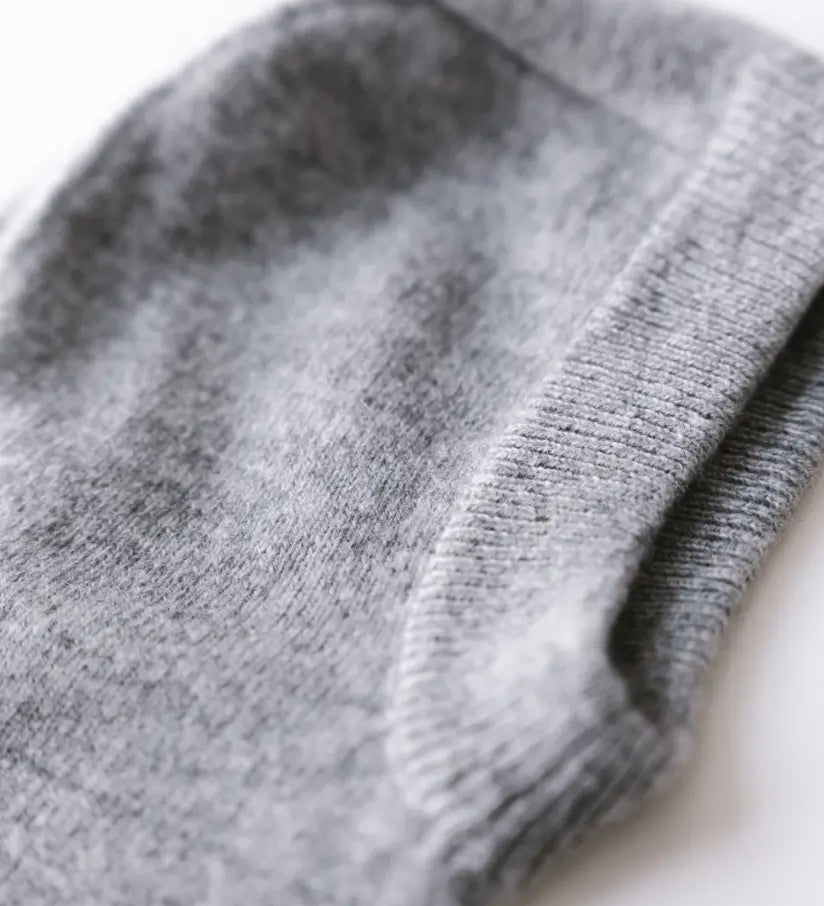 Close-up of heather grey cashmere knit balaclava showing soft texture and ribbed edge.