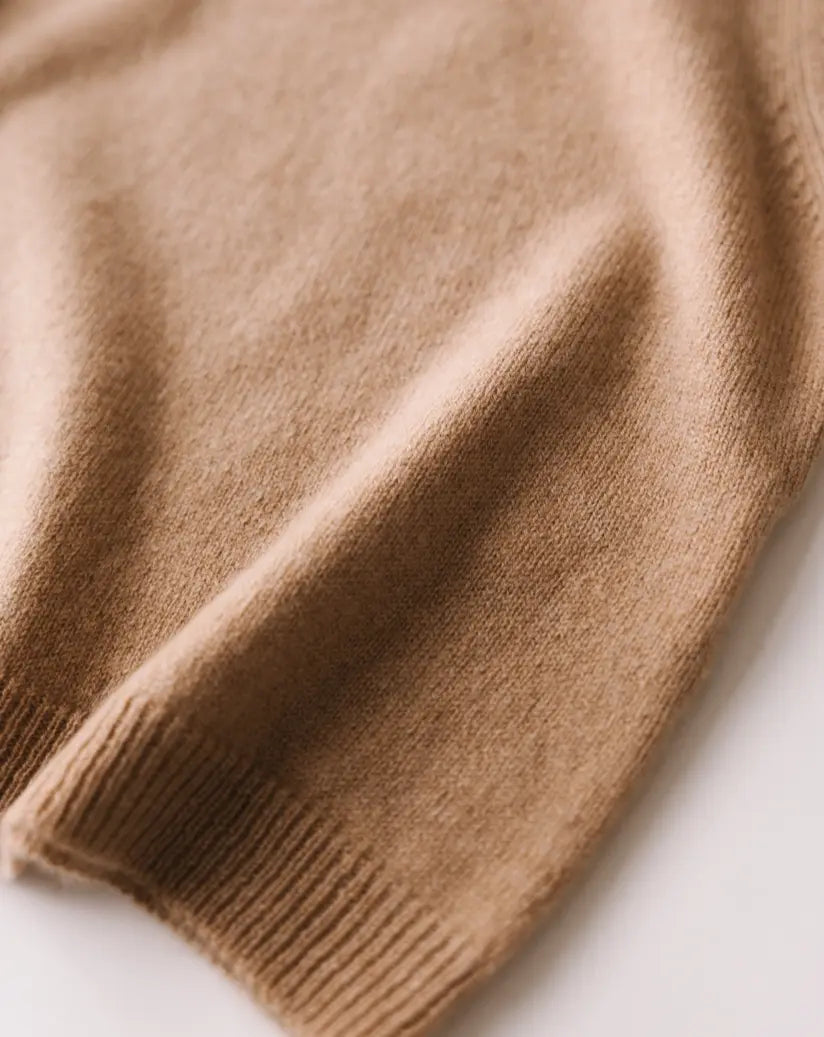 Close-up of the soft knit texture of the caramel brown baby cashmere sweater.