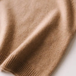 Close-up of the soft knit texture of the caramel brown baby cashmere sweater.
