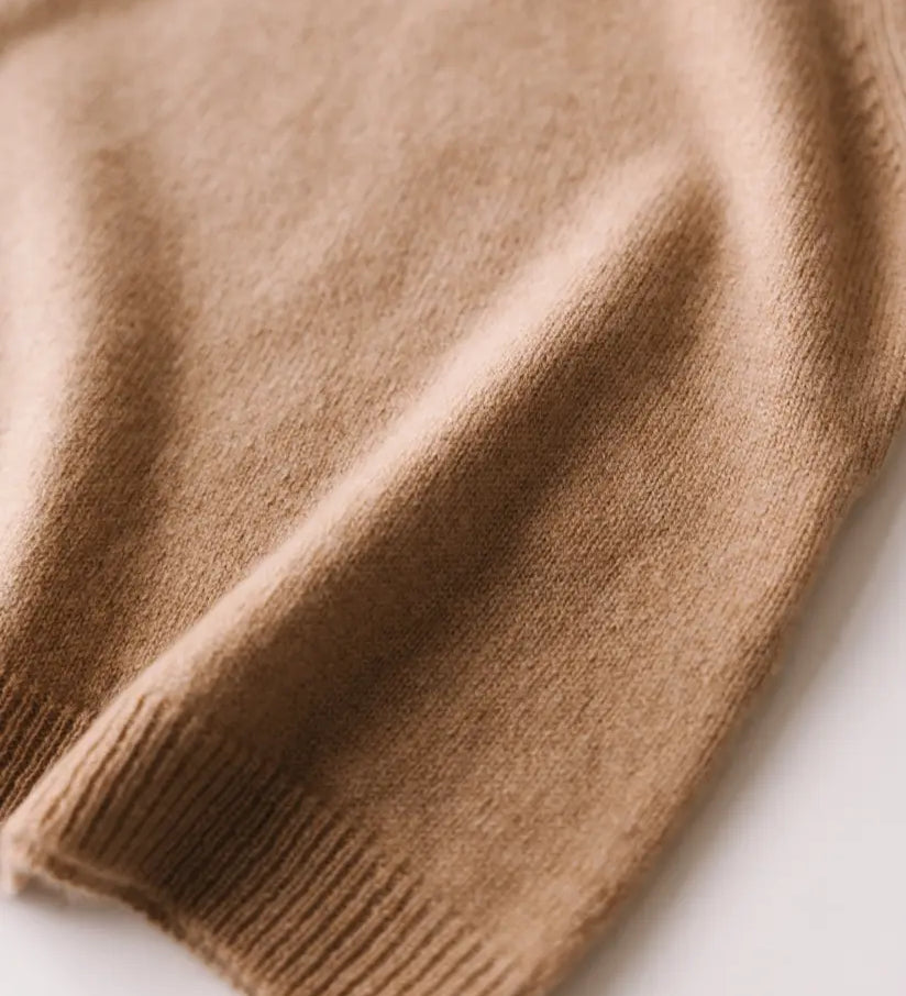 Close-up of the soft knit texture of the caramel brown baby cashmere sweater.