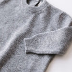 Close-up knit texture of heather grey baby cashmere sweater