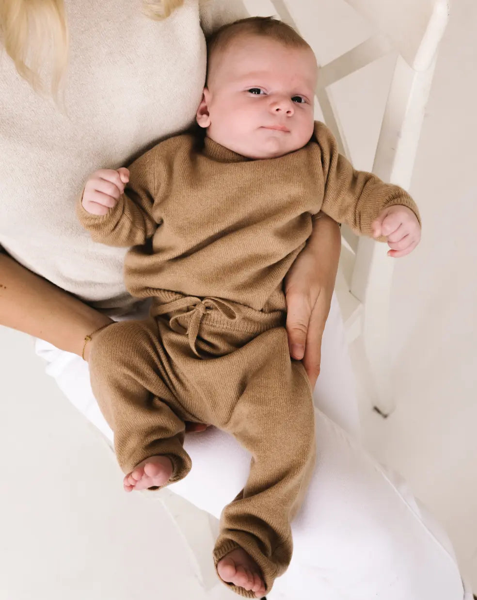 Baby wearing caramel brown cashmere pants with matching knitwear set.