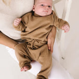 Baby wearing caramel brown cashmere pants with matching knitwear set.
