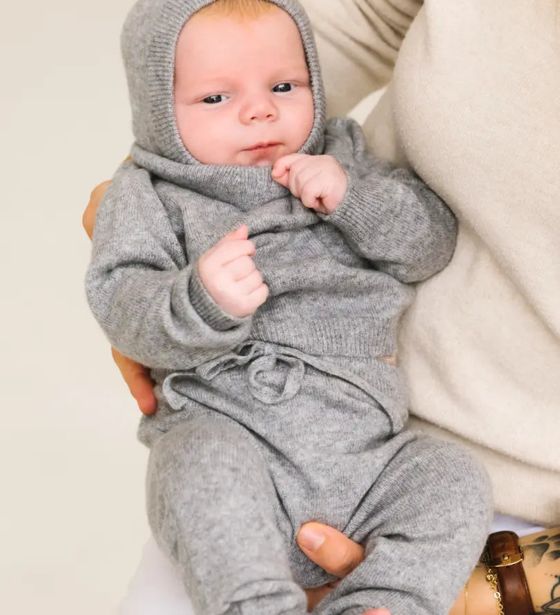 Baby wearing heather grey cashmere pants and matching set.