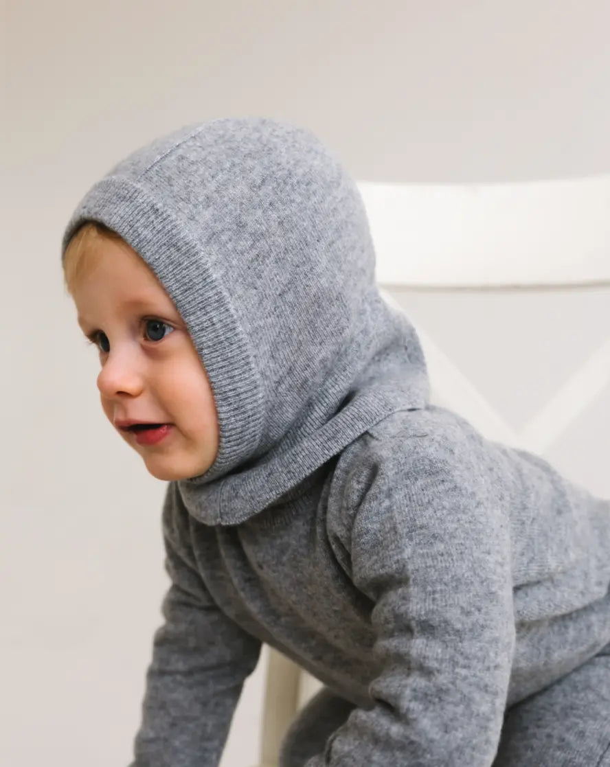 Side view of toddler wearing heather grey cashmere balaclava keeping head and ears warm.