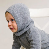 Side view of toddler wearing heather grey cashmere balaclava keeping head and ears warm.